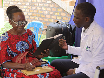A woman gets her eyes checked during a medical outreach event in Uganda