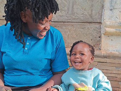 Cheerful Baby Amaya smiling with her caregiver