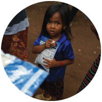 A young refugee in Cambodia receiving food outreach