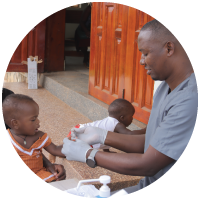 A doctor treating a child during medical outreach in Uganda