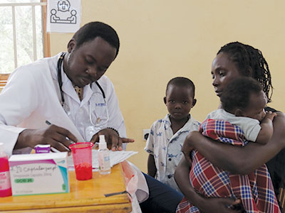 A doctor works with a mother and her young children