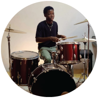 A young man in the Dominican Republic playing the drums during church