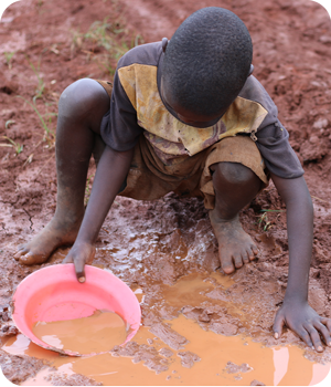 A child collecting dirty water A child collecting dirty water