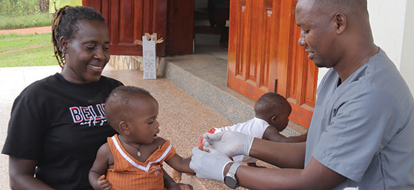 A doctor treating a child during medical outreach in Uganda