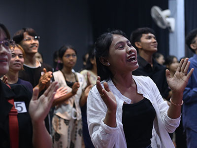 Young adults worshipping during a youth event in Cambodia