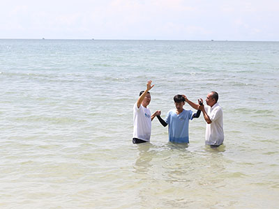 A young man getting baptized during an event in Cambodia