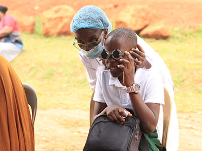 A child has their eyesight checked during a medical outreach event in Uganda