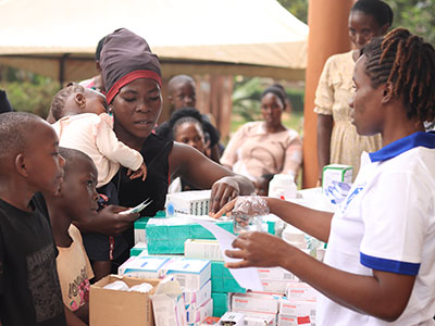 A woman receives care during a medical outreach event in Uganda