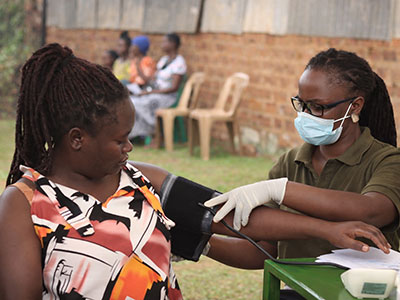 A woman receives care during a medical outreach event in Uganda