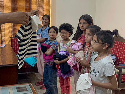 The Kinship Kids at the Lahore Kinship Family in Pakistan receiving new clothes.